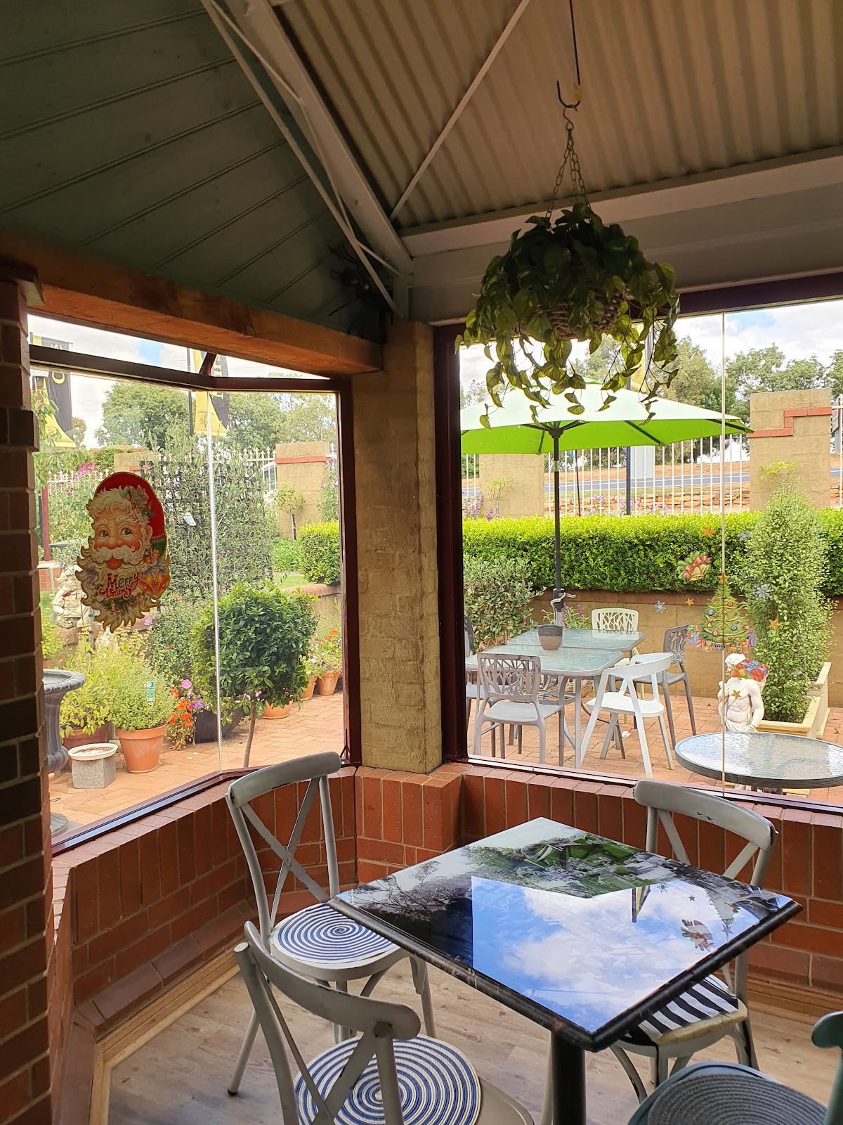Tables on the Antz Pantz Cafe verandah looking out over the garden